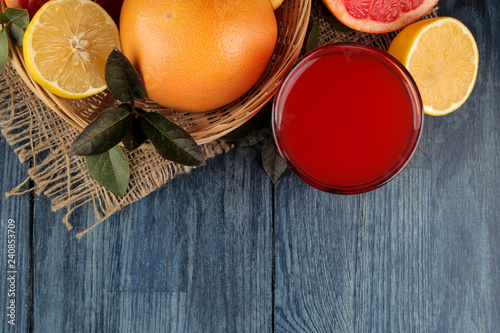 Citrus juices. grapefruit juice with fresh fruit on a blue wooden table. view from above. space for text