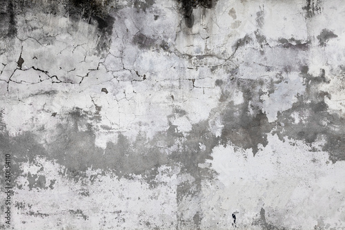 Cracked concrete wall covered with gray cement surface. Old grunge textures b...
