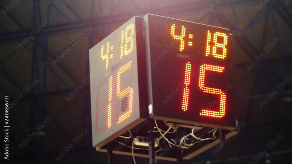 Sports shot clock countdown. Glowing LED screen shows the information. The numbers gets in focus