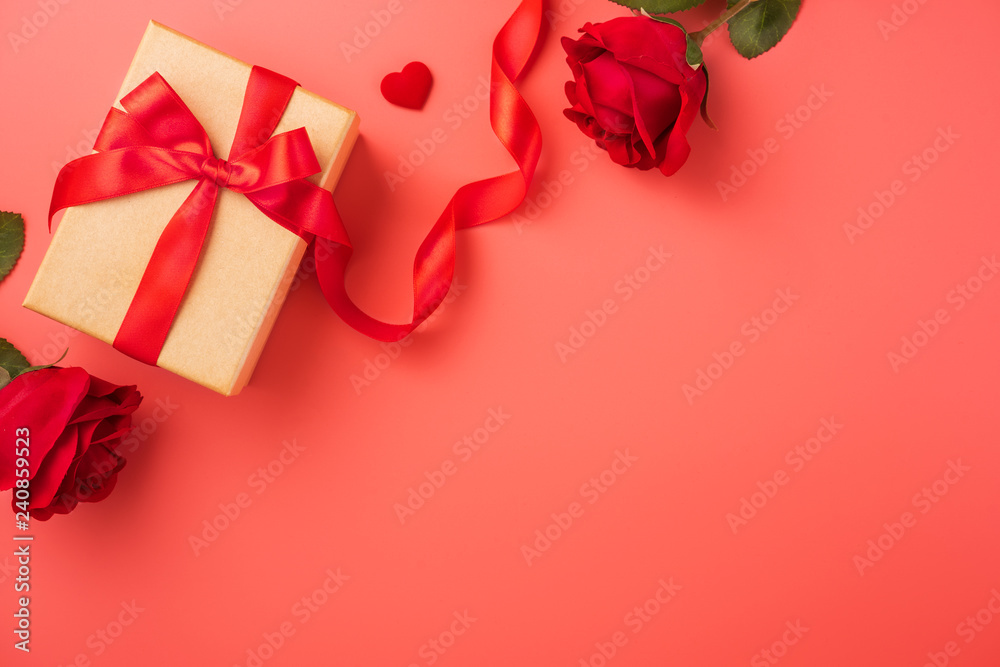 Gift box with red ribbon and rose in trendy colour of 2019 living coral, concept of Valentine's, anniversary, mother's day, copy space, top view.