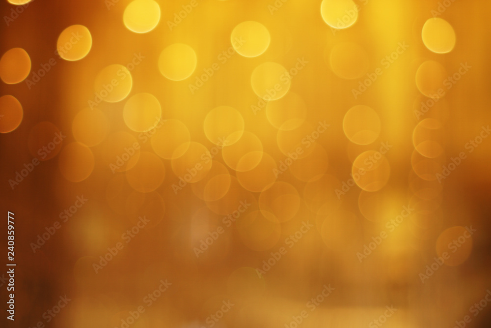 The golden bokeh blurred abstract pattern background. The golden bokeh blurred abstract pattern background.