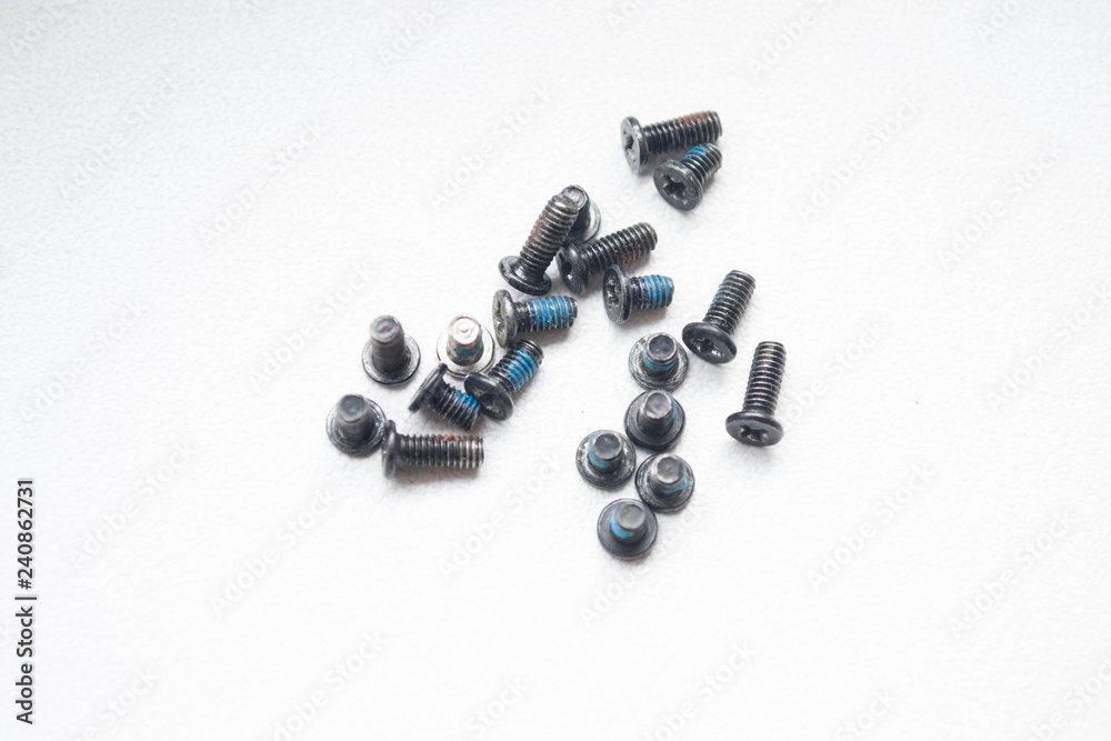 A group of bolts lying on the center of a gray background close-up A group of bolts lying on the center of a gray background close-up