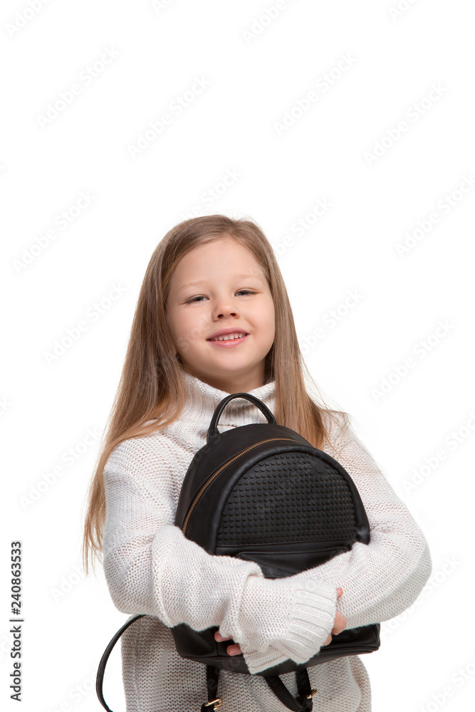 portrait of cute little kid girl in stylish clothes looking at camera and smiling against white studio wall. Kids fashion concept portrait of cute little kid girl in stylish clothes looking at camera and smiling against white studio wall. Kids fashion concept