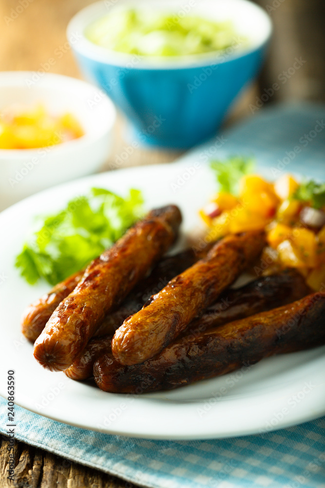 Fried sausages with fruit salsa