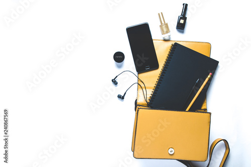 Women's handbag and accessories on white background. Flat lay and top view