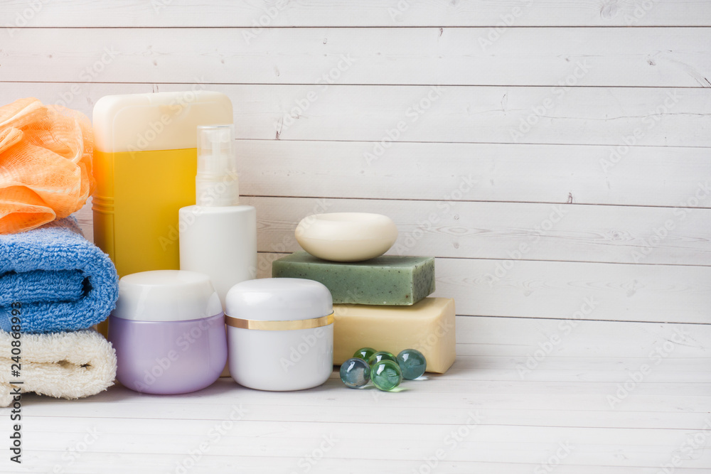 Spa and Wellness concept on white background. Towels cream soap and bath accessories. Copy space Spa and Wellness concept on white background. Towels cream soap and bath accessories. Copy space