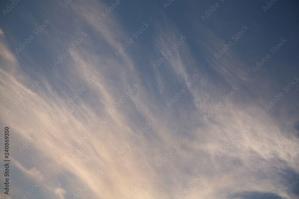 The bright background of the sky is covered with beautiful clouds. Very light clouds and sky soar across the horizon. Wind accelerates paint with a blue background image of nature.
