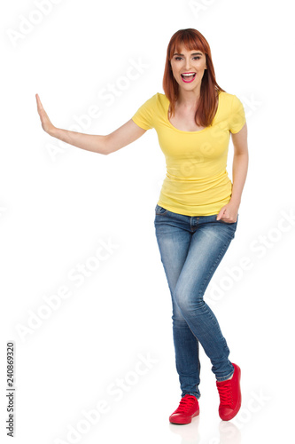 Front View Of Excited Young Woman Pushing Something With One Hand