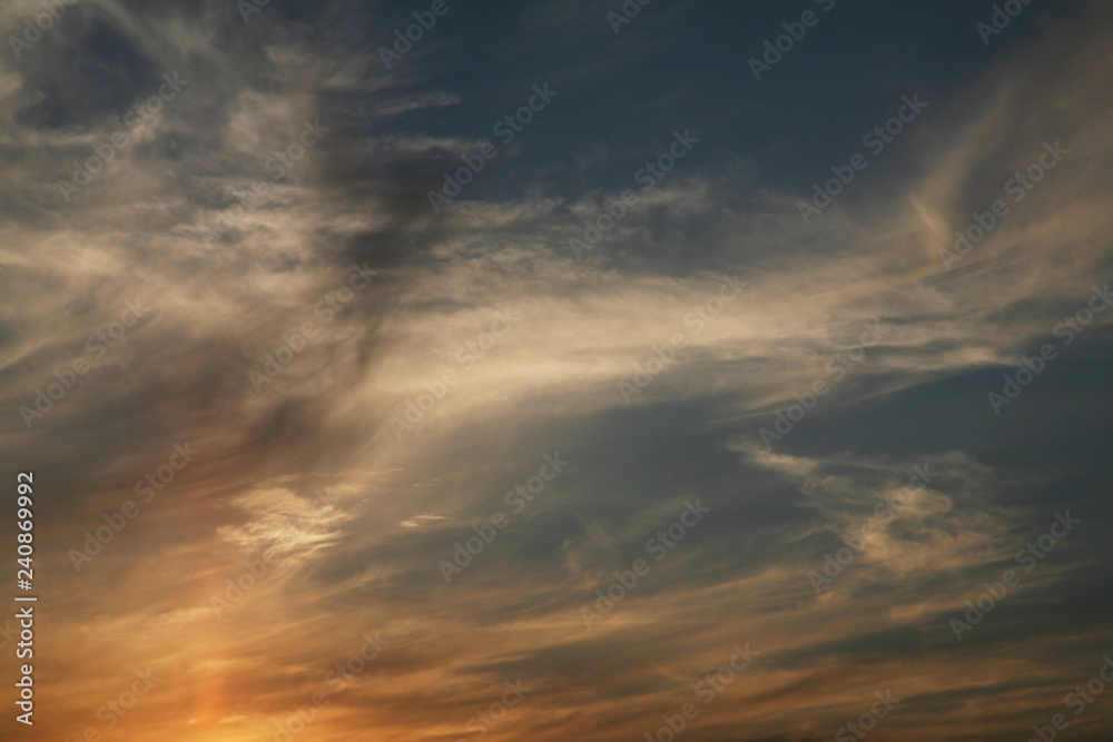 The sun  rays illuminate the sky with clouds. We see the background of the sky of natural color as in the picture. This image of a beautiful sky and white clouds pleases all people.