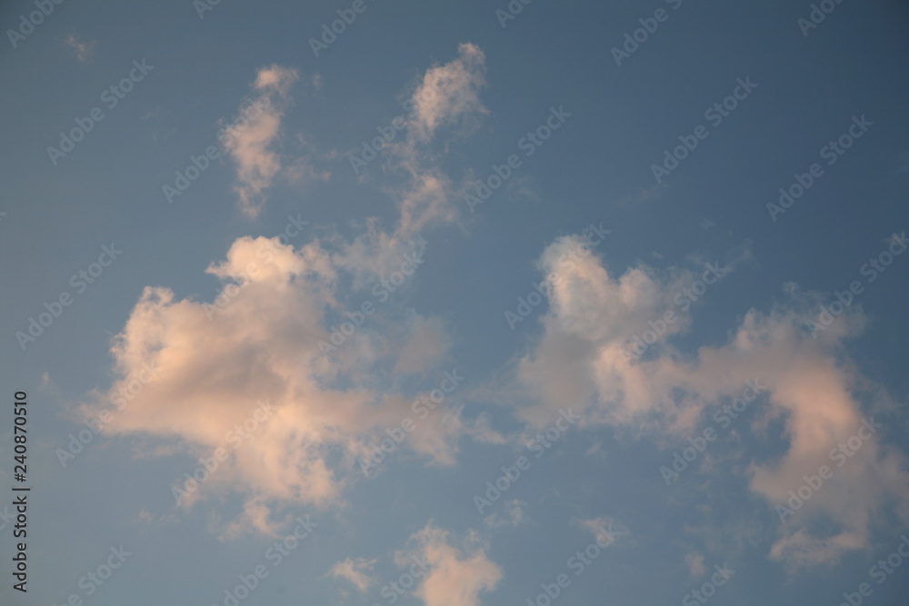 Beautiful clouds float across the blue sky. This background is illuminated by the natural light of heaven. Beautiful clouds and the sky are illuminated by bright light. Beautiful clouds float across the blue sky. This background is illuminated by the natural light of heaven. Beautiful clouds and the sky are illuminated by bright light.