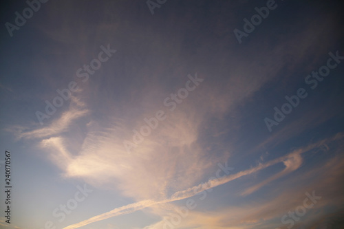 Sky clouds as the best picture. The most abstract background image of the sky. Beautiful sunset. The sun  rays illuminate the clouds. © Vitaly Kartashev