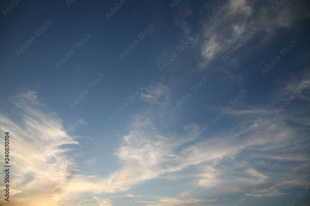 The bright background of the sky is covered with beautiful clouds. Very light clouds and sky soar across the horizon. Wind accelerates paint with a blue background image of nature.