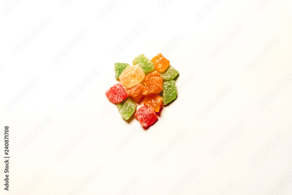 Multicolored candied dried fruits from pineapple isolate on a white background with a place to insert. Multicolored candied dried fruits from pineapple isolate on a white background with a place to insert.