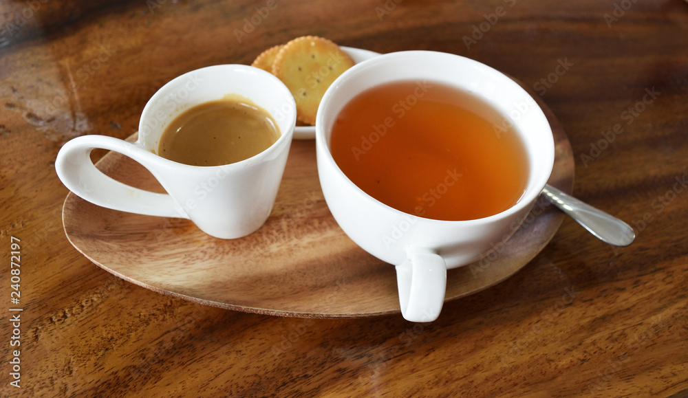 Obraz premium Espresso Coffee with hot tea in white cup and flatbread crackers on wooden table 