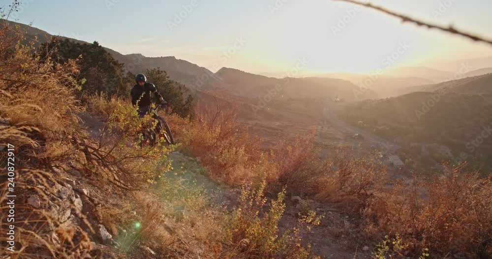 Mountain biker going up the road, following the path,and doing amazing jump - extreme, activity, getting away from it all Mountain biker going up the road, following the path,and doing amazing jump - extreme, activity, getting away from it all