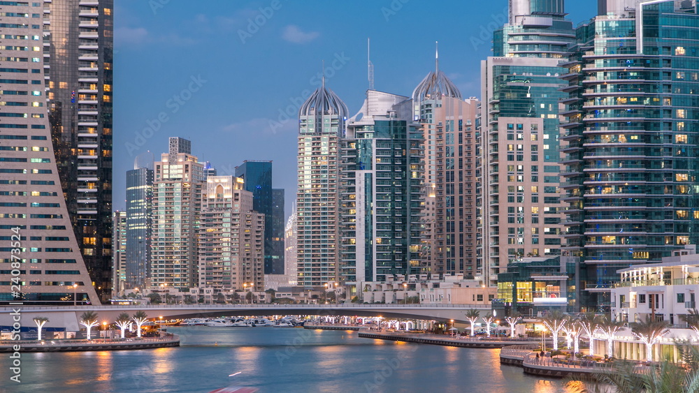 Obraz premium View of Dubai Marina Towers and canal in Dubai day to night timelapse
