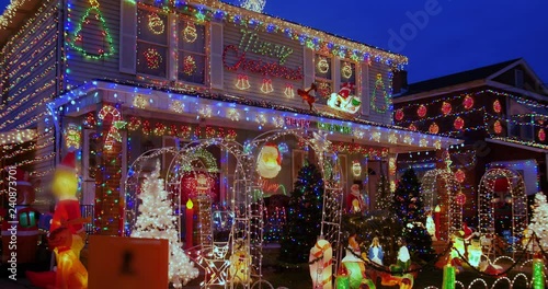 A three-quarter establishing shot of houses heavily decorated for Christmas. Pittsburgh suburbs.  	 photo