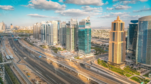 Aerial view of Dubai marina skyscrapers and Jumeirah lakes towers timelapse with traffic on sheikh zayed road.