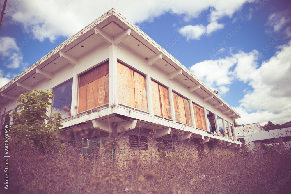 Abandoned hotel building with vintage mid-century modern architectural style