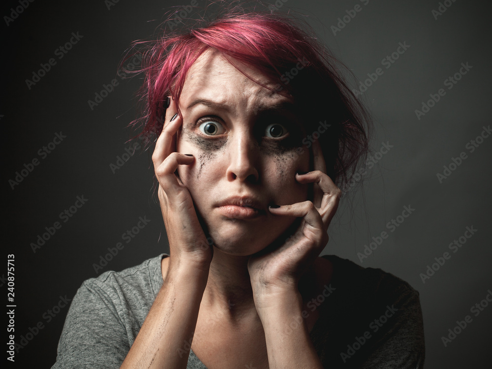 Scared young woman with smeared make up