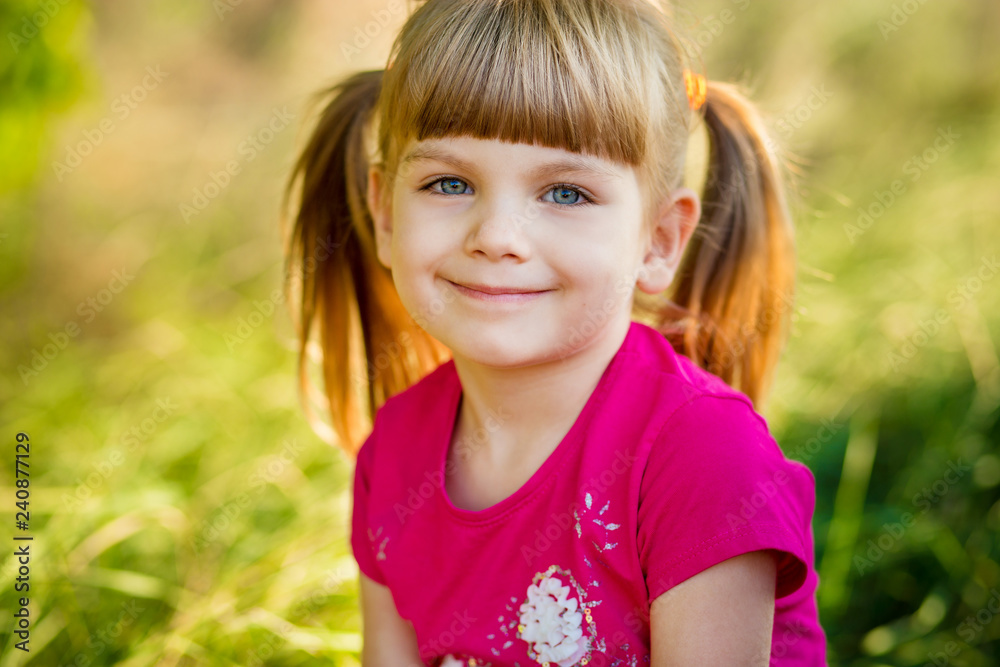 Outdoor portrait of little girl in urban setting smiles at camera. Outdoor portrait of little girl in urban setting smiles at camera.