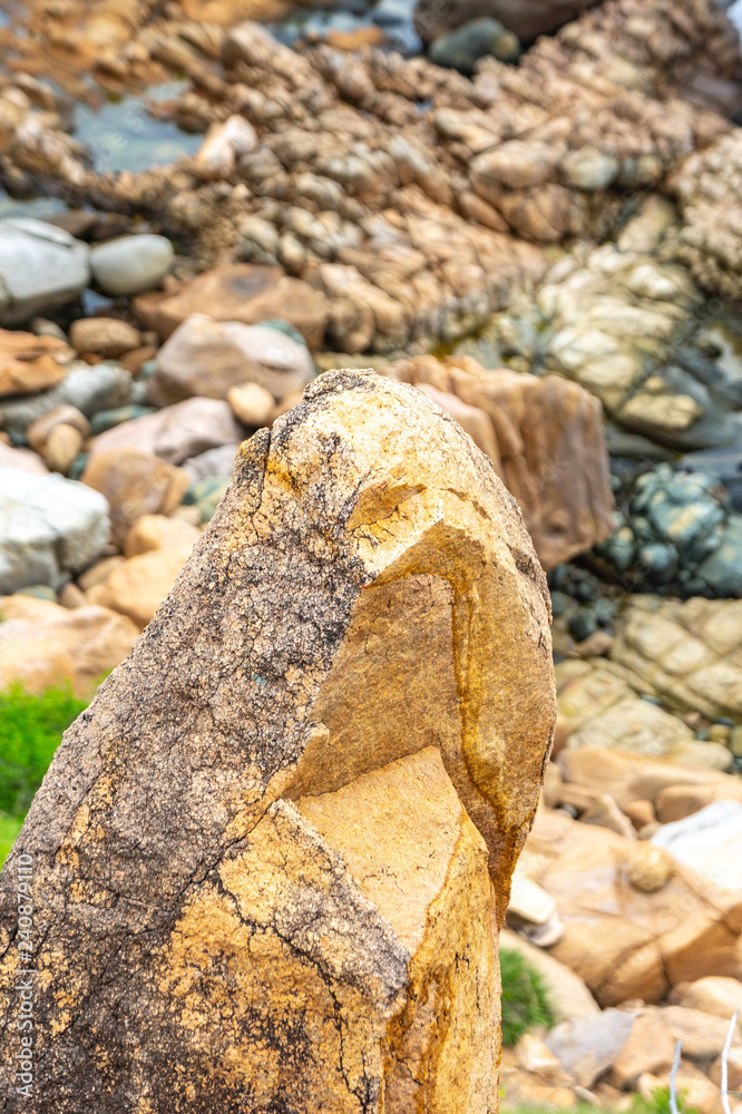 Fototapeta premium Macro shooting of a stone on the seashore against a background of stones