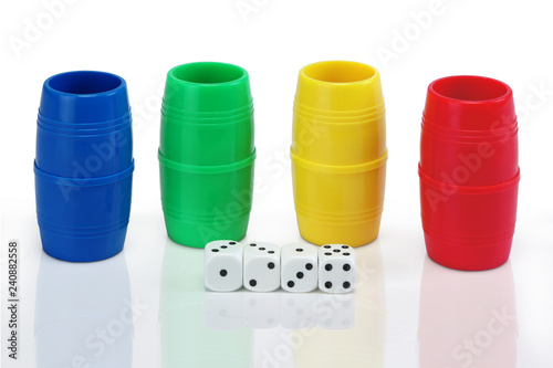 four shaker of different colors and dices