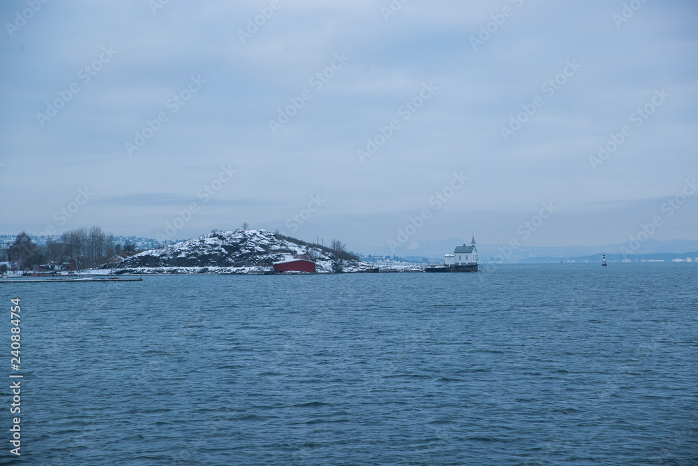 Obraz premium Cliffs on the islands around Oslo Norway over the winter overlooking the sea and the Fjord on horizont