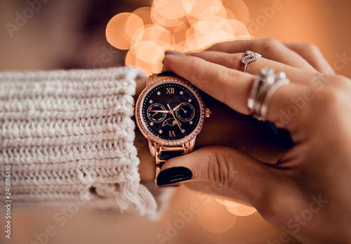 Stylish gold watch on woman hand