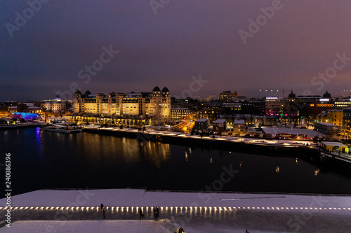 Overlooking the city center of Oslo Norway during the winter all covered with fresh snow during the evening time