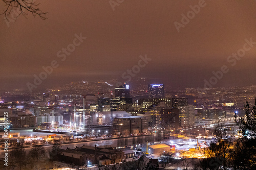 Overlooking the city center of Oslo Norway during the winter all covered with fresh snow during the evening time