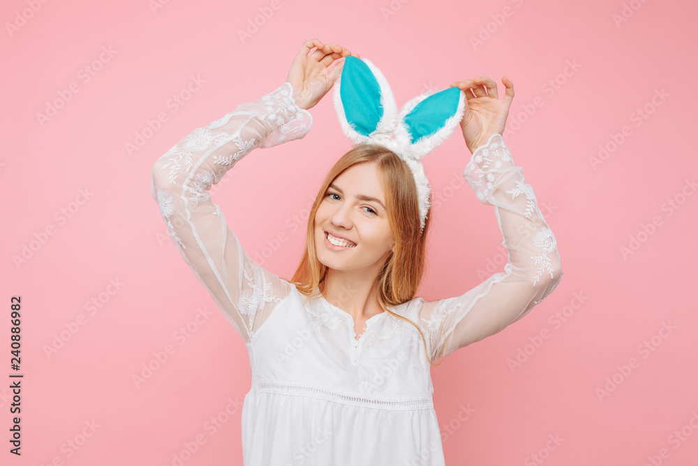 Beautiful young woman with Easter bunny ears, over pink background. Valentine's Day Concept Beautiful young woman with Easter bunny ears, over pink background. Valentine's Day Concept