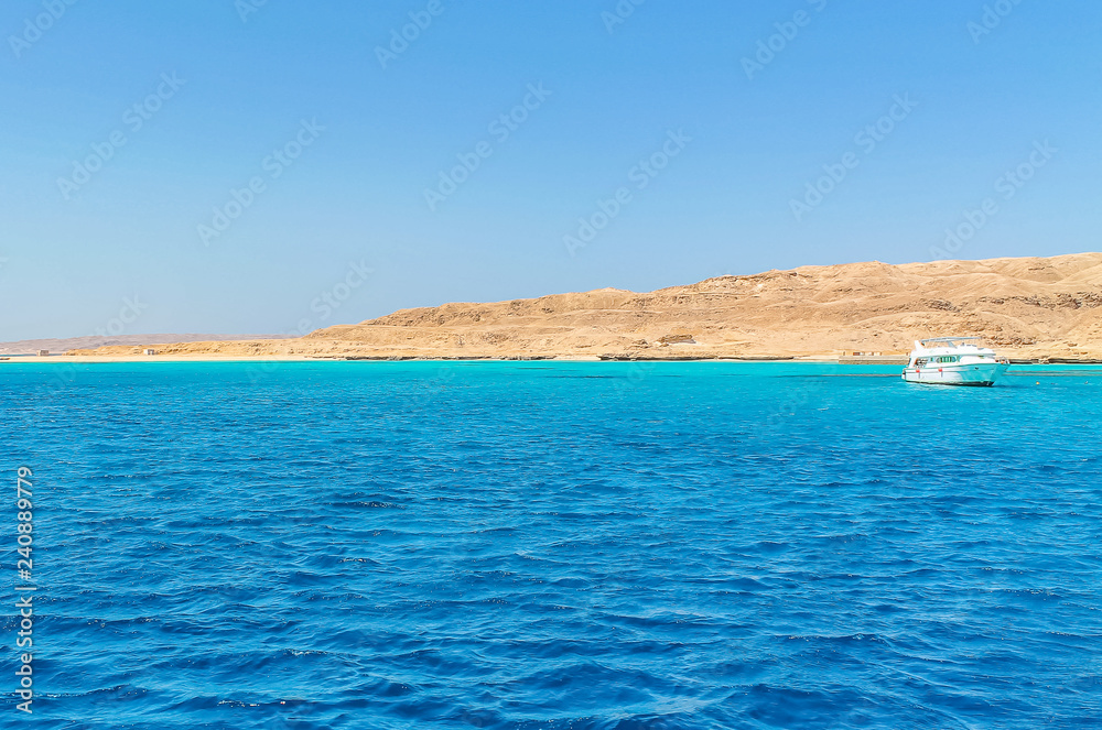 White yacht on a sunny day on the red sea surrounded by clear blue water