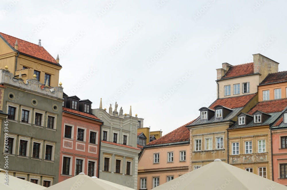 White umbrellas and colorful buildings in Warsaw,  Poland