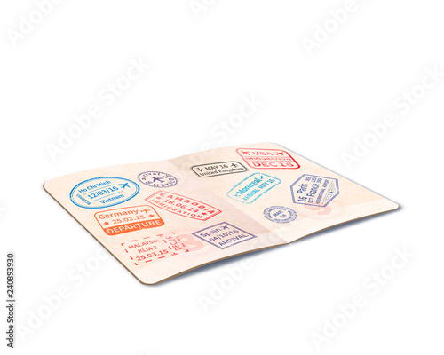 Open foreign passport full of immigration stamps, travel document in perspective on white