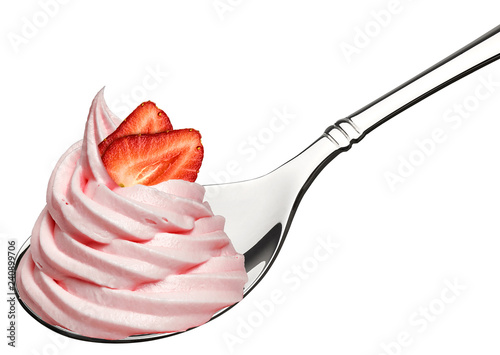 Whipped frozen yogurt or cream and strawberry in spoon isolated on white background. photo