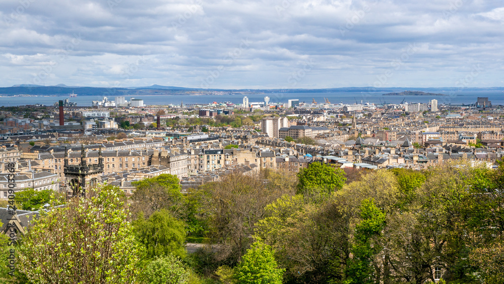 Landscape of the city of Edinburgh in Scotland. Cityscape with medieval and modern architecture on a cloudy day, view from Calton Hill.