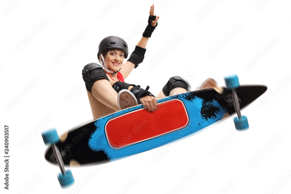 Naklejka premium Young female skater jumping with a longboard