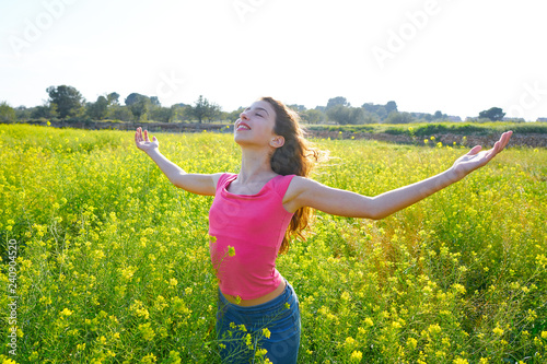open arms happy teen girl in spring meadow