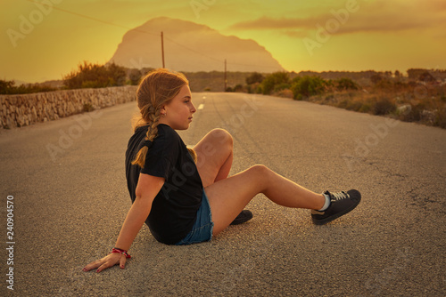 Blond girl sitting on the road with Montgo photo