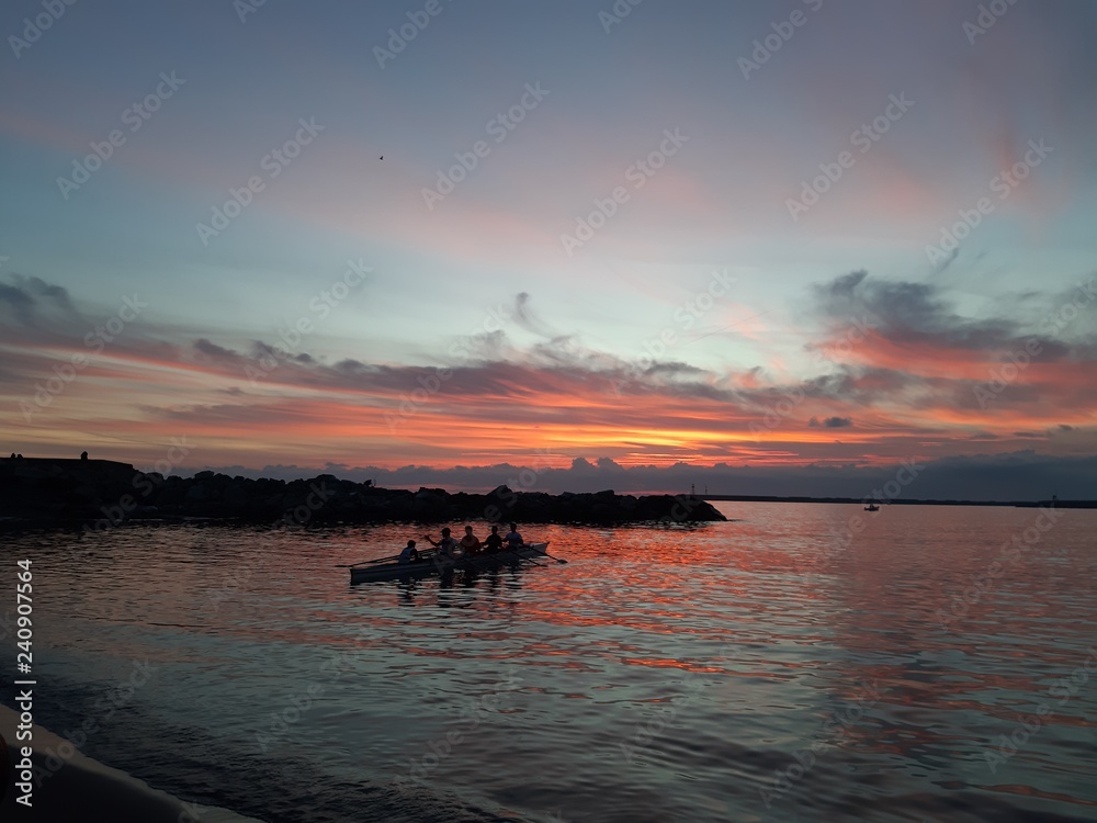 An amazing caption of small waves and beautiful sunset with an incredible reflection over the sea and some coloured clouds in winter days