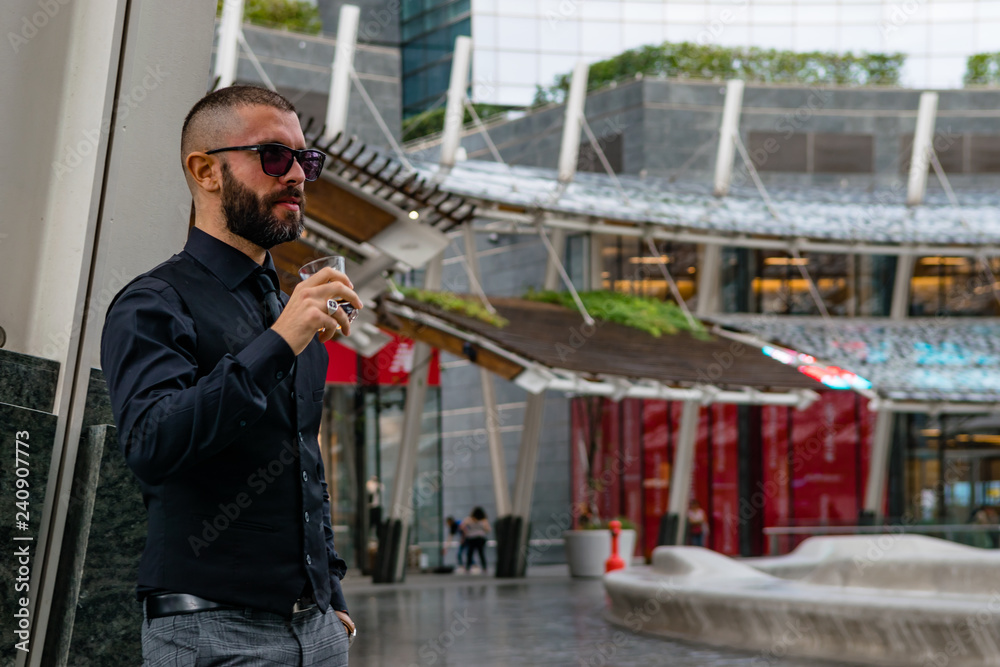 Fototapeta premium Man drinking a whiskey in Milan