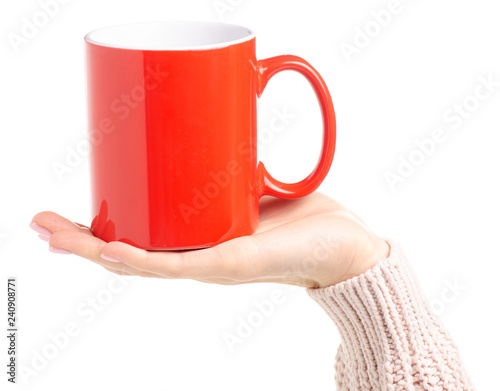 Red cup mug in female hand on white background isolation