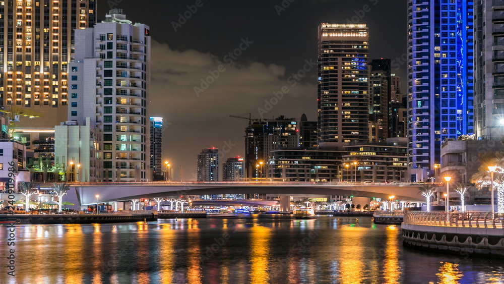 Naklejka premium View of Dubai Marina Towers and canal in Dubai night timelapse