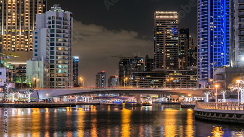 View of Dubai Marina Towers and canal in Dubai night timelapse