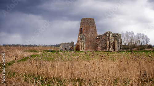 UK, NORFOLK - MARCH 2018: St Benet's Abbey gatehouse and mill on the Norfolk Broads during a winter storm.