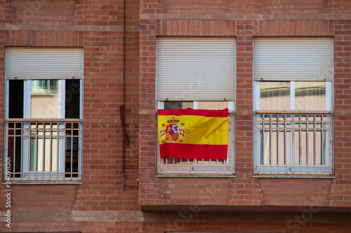 Flag of Spain hanging on the balcony of a house as a symbol of support for Spanish nationalism in the face of Catalan independence