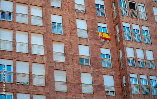 Flag of Spain hanging on the balcony of a house as a symbol of support for Spanish nationalism in the face of Catalan independence