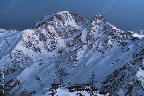 Shelter of barrels on the background of the peaks of Donguz-Orun and Nakra-Tau. Russia, Kabardino-Balkaria, Elbrus region.