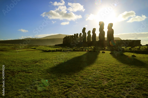Silhouette of Moai statues against dazzling sunrise sky at Ahu Tongariki, the largest celemonial platform on Easter Island, Chile, South America